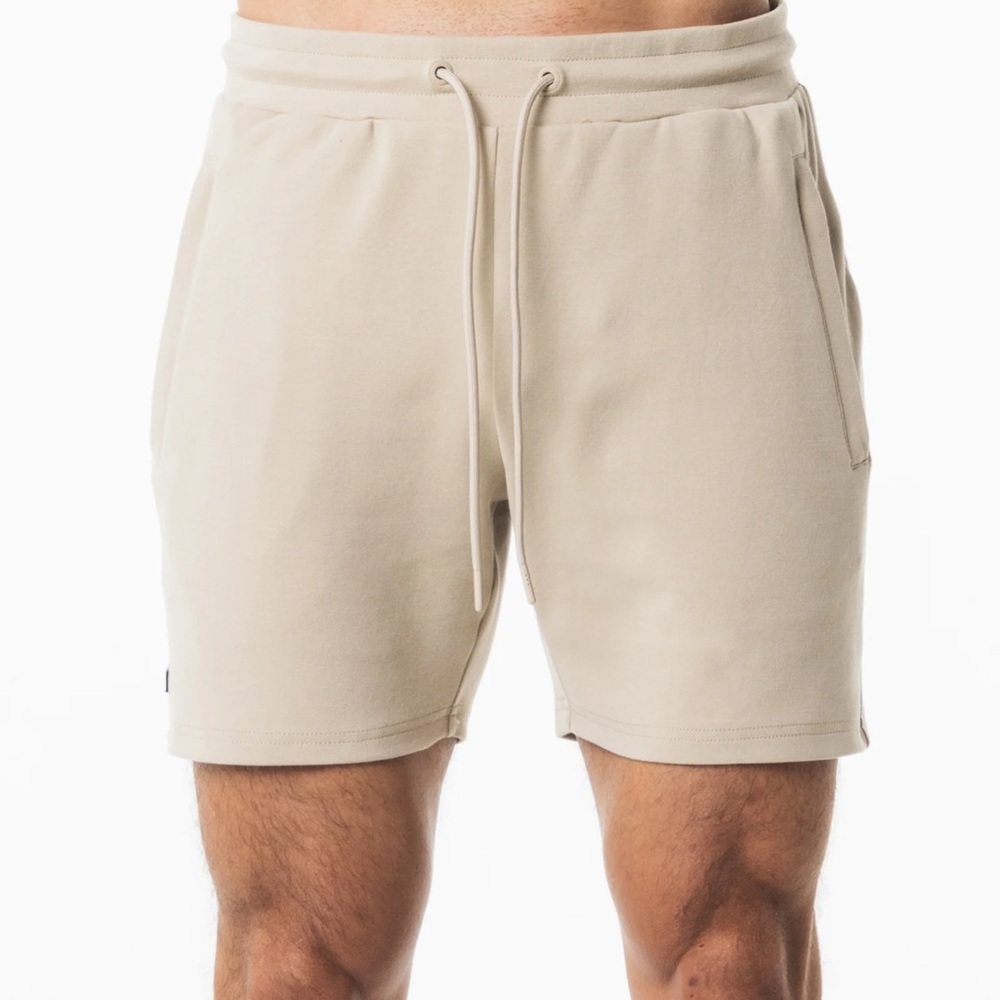 Alphalete Cream Athletic Shorts with Elastic Waistband and Mid-Thigh Length